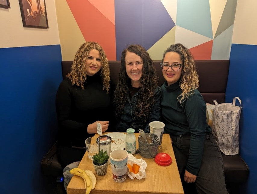 Three girls sitting in the cafe at Circus Hostel Berlin Germany 